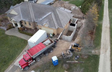 Stone sling backfilling excavation of house foundation renovation in Guelph