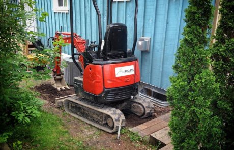 Mini Excavator digging foundation for walkway in small space