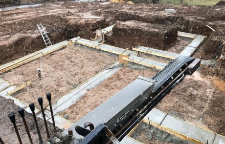 Stone slinger backfilling excvation for foundation with 3/4" stone